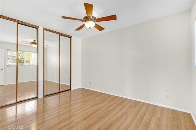 86 Sandpiper Unit 17, Irvine, CA 92604 - unfurnished bedroom with baseboards, a ceiling fan, multiple closets, and light wood-style flooring
