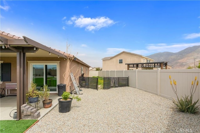 view of patio / terrace featuring a mountain view and fence