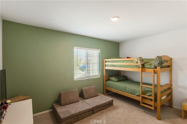 carpeted bedroom featuring baseboards