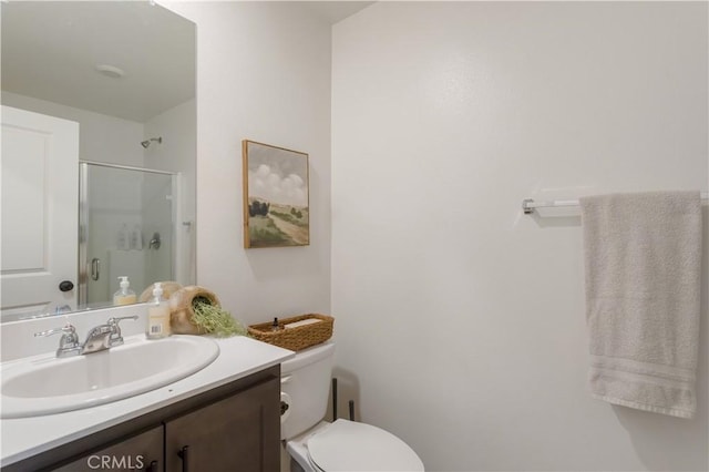 full bath featuring toilet, a shower stall, and vanity
