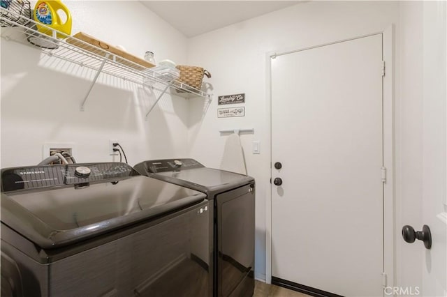clothes washing area featuring washing machine and clothes dryer and laundry area