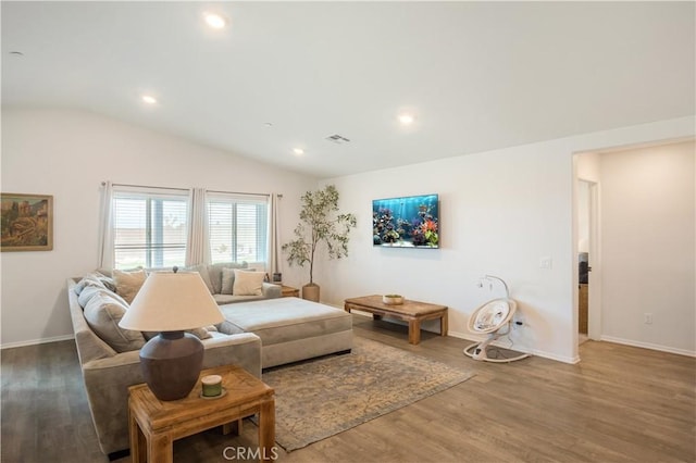 living room with visible vents, baseboards, recessed lighting, vaulted ceiling, and wood finished floors