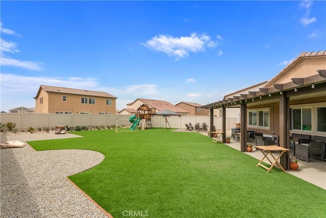 view of yard with a pergola, a playground, a fenced backyard, and a patio area