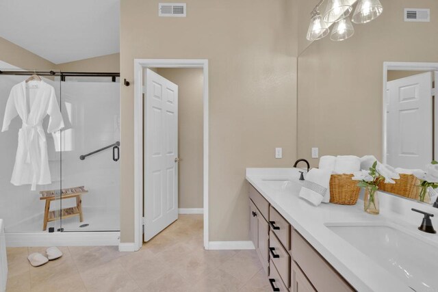 bathroom with a sink, a shower stall, and visible vents