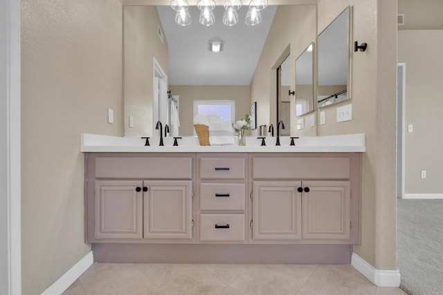 full bath with a sink, baseboards, double vanity, and visible vents