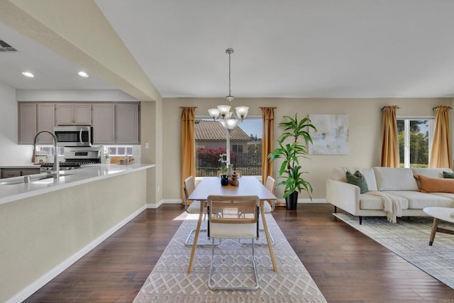 dining room featuring visible vents, baseboards, recessed lighting, dark wood finished floors, and a notable chandelier