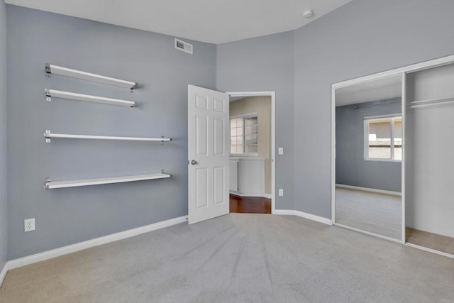 unfurnished bedroom with visible vents, baseboards, carpet floors, and a closet