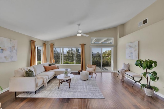 living area featuring visible vents, ceiling fan, lofted ceiling, and wood finished floors