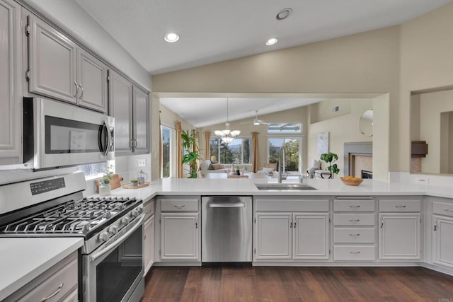 2487 Columbine Dr, Alpine, CA 91901 - kitchen featuring stainless steel appliances, vaulted ceiling, light countertops, dark wood-style flooring, and a peninsula