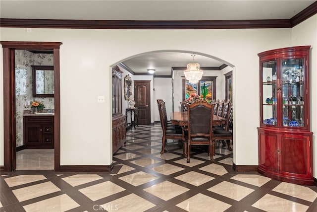 dining room featuring baseboards, arched walkways, a notable chandelier, and crown molding