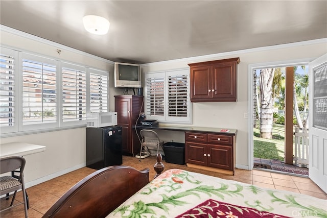 bedroom featuring freestanding refrigerator, baseboards, access to outside, and light tile patterned floors