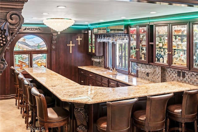 bar with indoor wet bar and a sink
