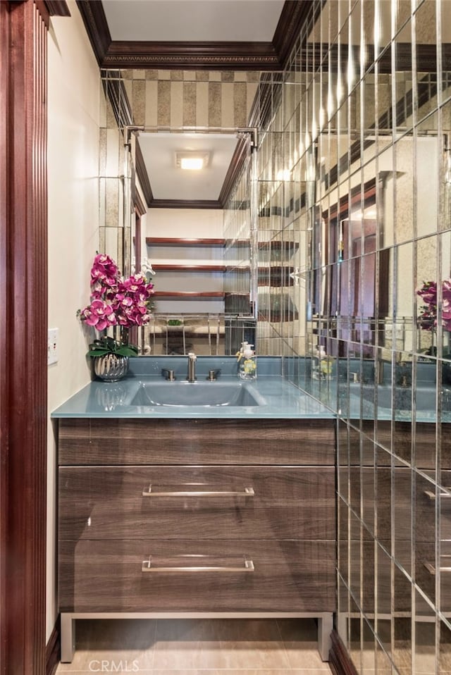 bar with ornamental molding and a sink