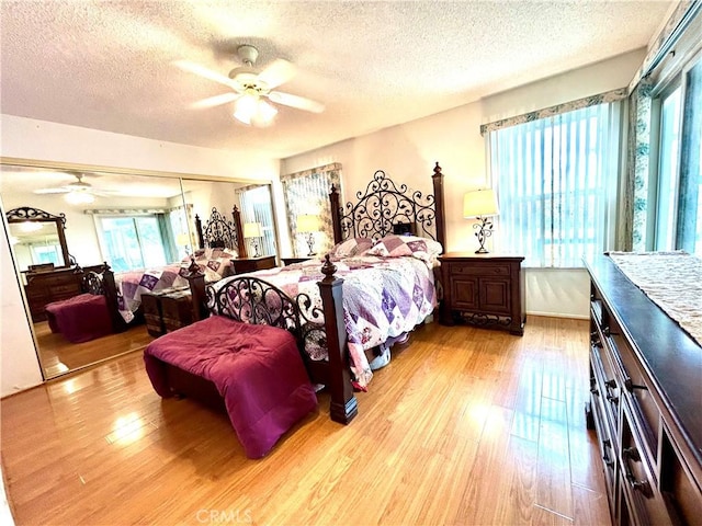 26221 Germantown Dr, Menifee, CA 92586 - bedroom with a textured ceiling, wood finished floors, multiple windows, and a ceiling fan