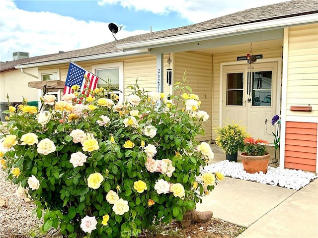 26221 Germantown Dr, Menifee, CA 92586 - property entrance with covered porch and a shingled roof
