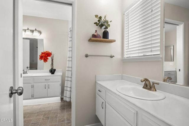 bathroom with stone finish flooring and vanity