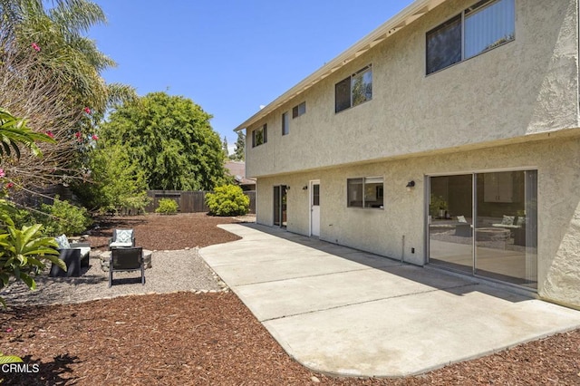 back of property featuring a patio, fence, and stucco siding
