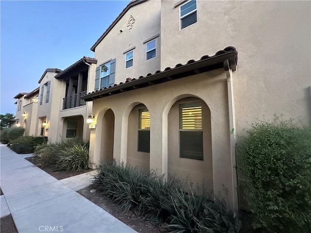 view of side of home with stucco siding