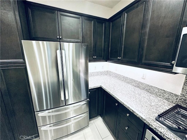 kitchen featuring dark cabinets and appliances with stainless steel finishes