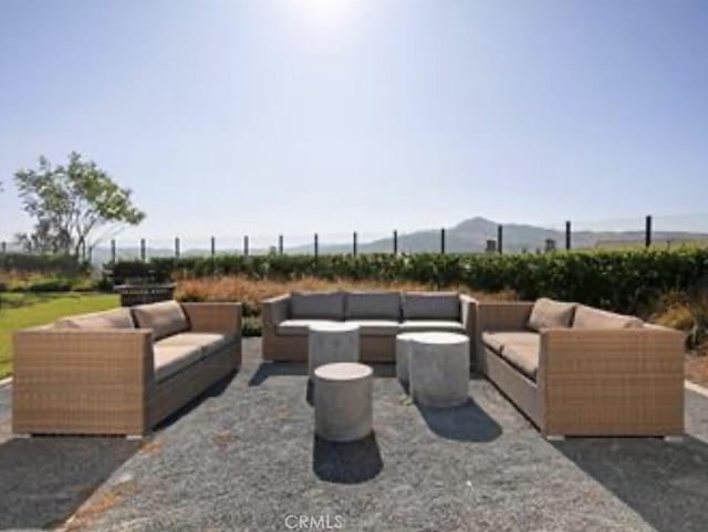 view of patio with an outdoor living space and a mountain view