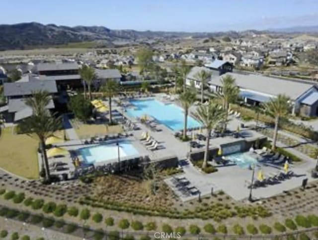 birds eye view of property with a mountain view