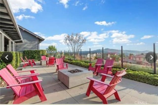 view of patio / terrace featuring a fire pit and a mountain view