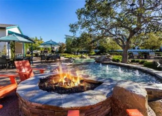view of pool with an outdoor fire pit