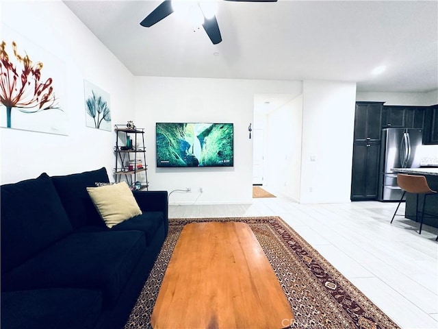 living area with a ceiling fan