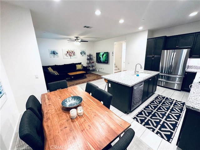 kitchen with a sink, ceiling fan, stainless steel appliances, visible vents, and recessed lighting