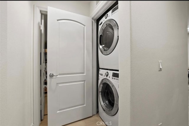 94 Jaripol Cir, Rancho Mission Viejo, CA 92694 - laundry area featuring stacked washer and clothes dryer and light wood-style flooring