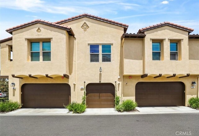 94 Jaripol Cir, Rancho Mission Viejo, CA 92694 - mediterranean / spanish-style home with an attached garage, stucco siding, and a tile roof