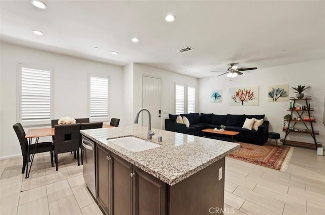 94 Jaripol Cir, Rancho Mission Viejo, CA 92694 - kitchen with a sink, stainless steel dishwasher, ceiling fan, dark brown cabinets, and an island with sink