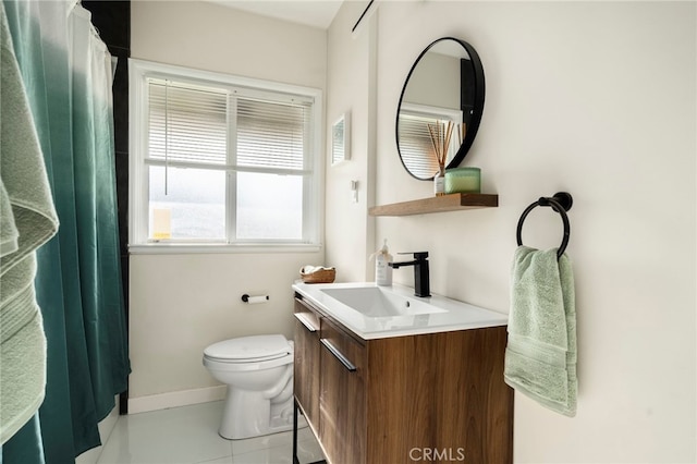 full bathroom featuring toilet, vanity, tile patterned floors, and baseboards