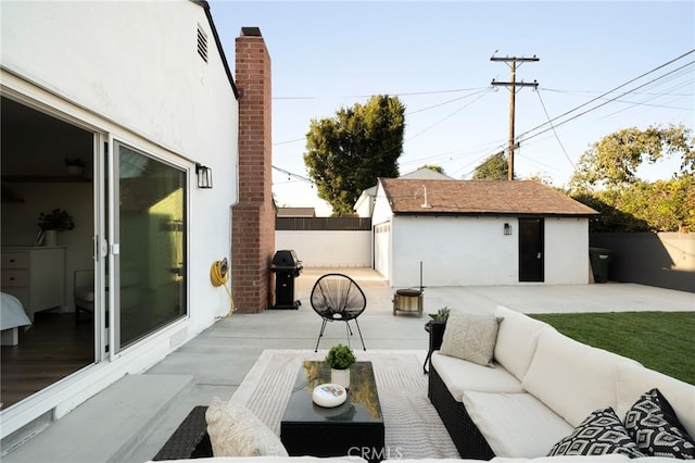 view of patio with an outbuilding, a fenced backyard, and an outdoor living space