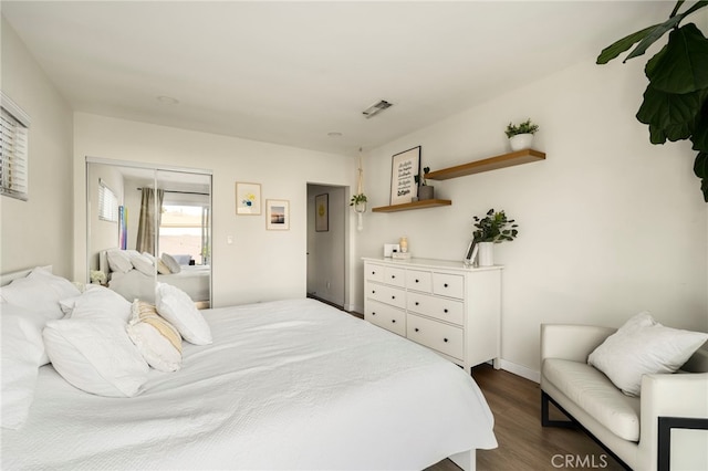 bedroom featuring dark wood finished floors, baseboards, and visible vents