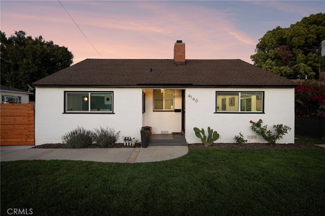 single story home featuring a shingled roof, a chimney, stucco siding, and fence
