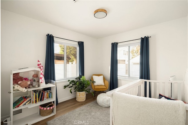 bedroom featuring wood finished floors and baseboards