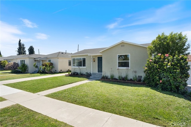 single story home with a front lawn, roof with shingles, and stucco siding