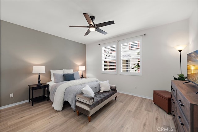 bedroom featuring baseboards, a ceiling fan, and light wood-type flooring