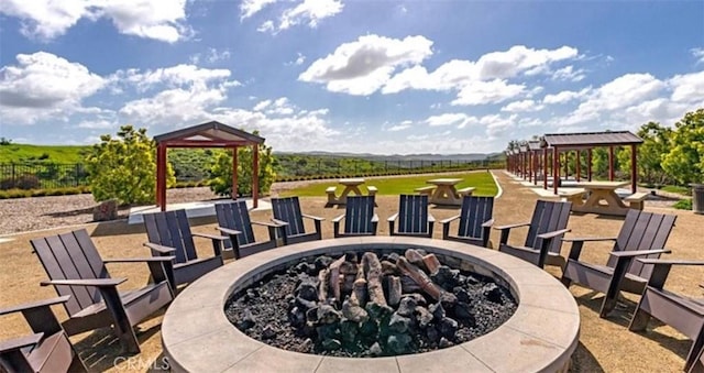 view of property's community featuring a gazebo and an outdoor fire pit