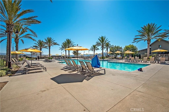 community pool featuring fence and a patio area