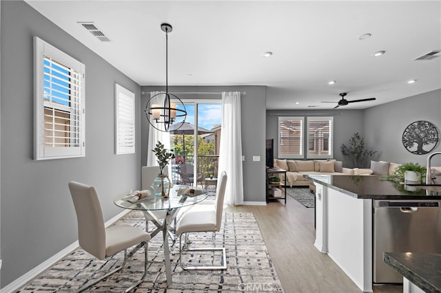 dining area featuring a wealth of natural light, visible vents, and baseboards