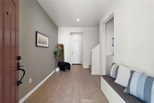 foyer featuring light wood finished floors and baseboards