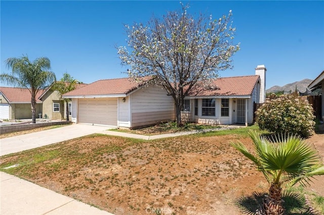 25448 Wedmore Dr, Moreno Valley, CA 92553 - single story home with a garage, a tile roof, a chimney, and concrete driveway