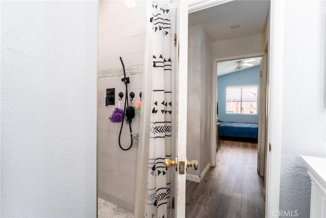 25448 Wedmore Dr, Moreno Valley, CA 92553 - full bath with tiled shower, baseboards, wood finished floors, ceiling fan, and a textured wall