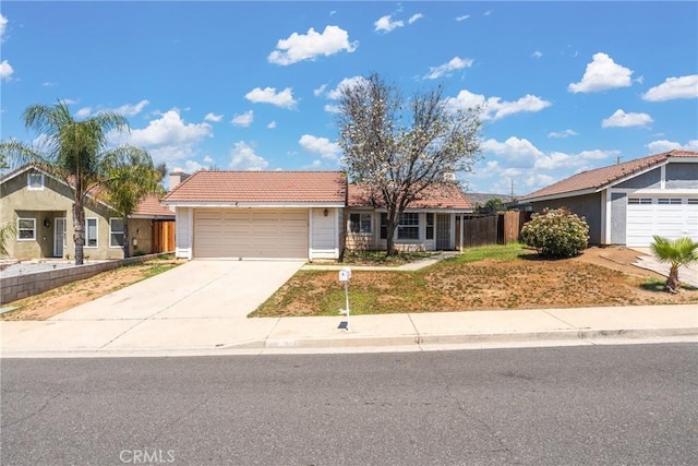 25448 Wedmore Dr, Moreno Valley, CA 92553 - single story home featuring fence, concrete driveway, stucco siding, a tile roof, and a garage