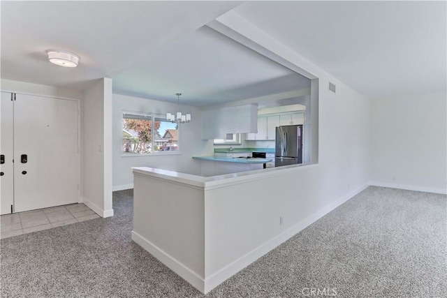 16591 Busby Ln, Huntington Beach, CA 92647 - kitchen featuring freestanding refrigerator, light colored carpet, a chandelier, baseboards, and a peninsula