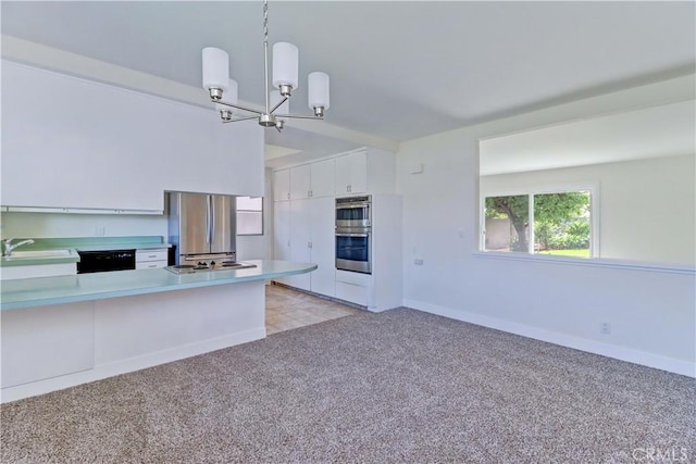 16591 Busby Ln, Huntington Beach, CA 92647 - kitchen with appliances with stainless steel finishes, a sink, light carpet, and light countertops