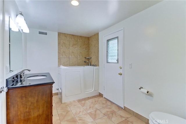 16591 Busby Ln, Huntington Beach, CA 92647 - bathroom featuring a bath, toilet, vanity, and tile patterned flooring