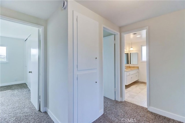 16591 Busby Ln, Huntington Beach, CA 92647 - hall featuring light carpet, plenty of natural light, and baseboards